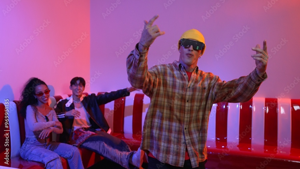 Fototapeta premium Caucasian break dancer perform movement while diverse friend sitting and dancing together. Happy hipster moving hand while multicultural group waving hand to support and encourage friend. Regalement.