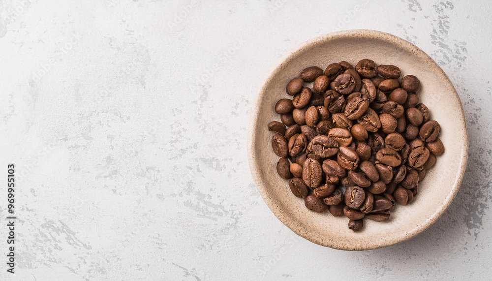 Roasted coffee beans in ceramic bowl, stone table. Tasty and aromatic beverage. Hot drink. Flat lay Roasted coffee beans in ceramic bowl, stone table. Tasty and aromatic beverage. Hot drink. Flat lay