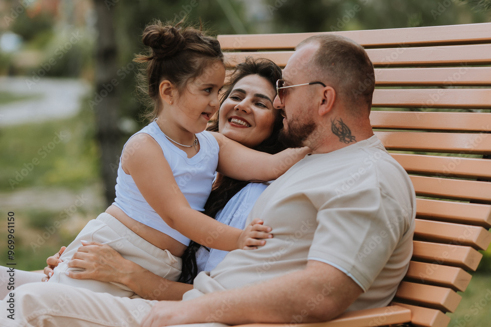 happy family is relaxing in the city park