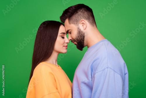 Photo of enamored enchanted couple wear stylish clothes isolated on green color background photo