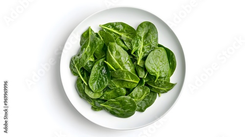 Fresh spinach leaves on a white plate: healthy and vibrant greens