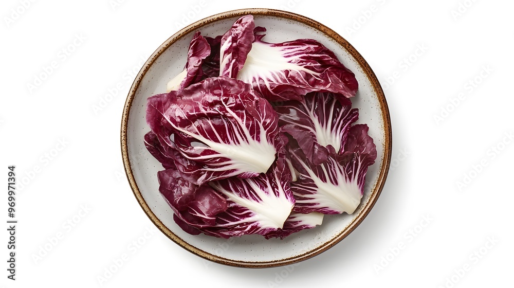 Fresh radicchio leaves on ceramic plate highlighting natural beauty and vibrant color Fresh radicchio leaves on ceramic plate highlighting natural beauty and vibrant color
