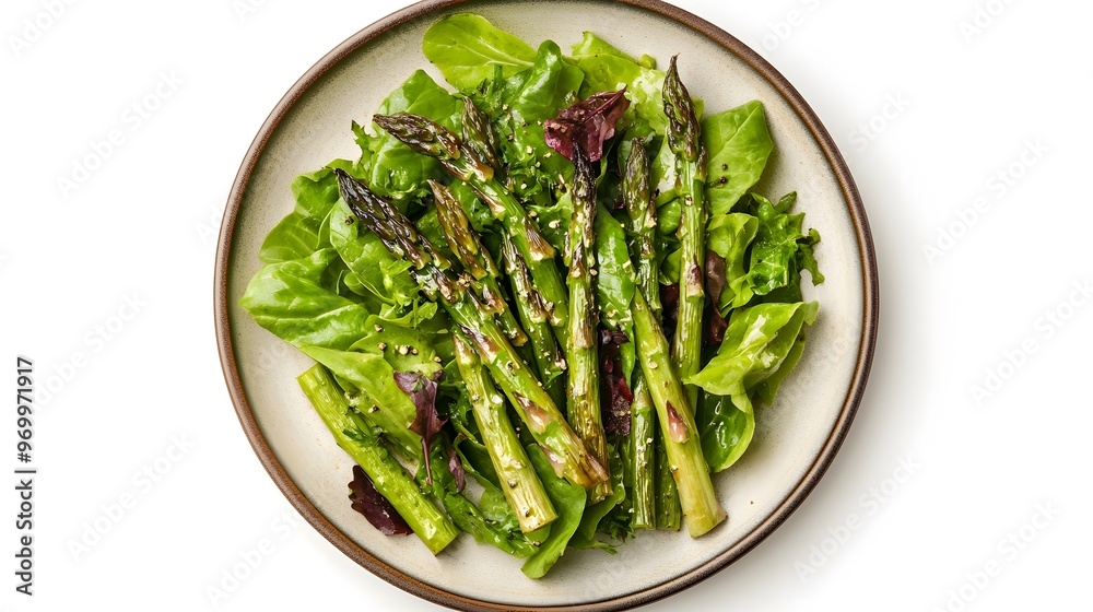 Fresh grilled asparagus on mixed leaf salad with sesame seeds on ceramic plate Fresh grilled asparagus on mixed leaf salad with sesame seeds on ceramic plate