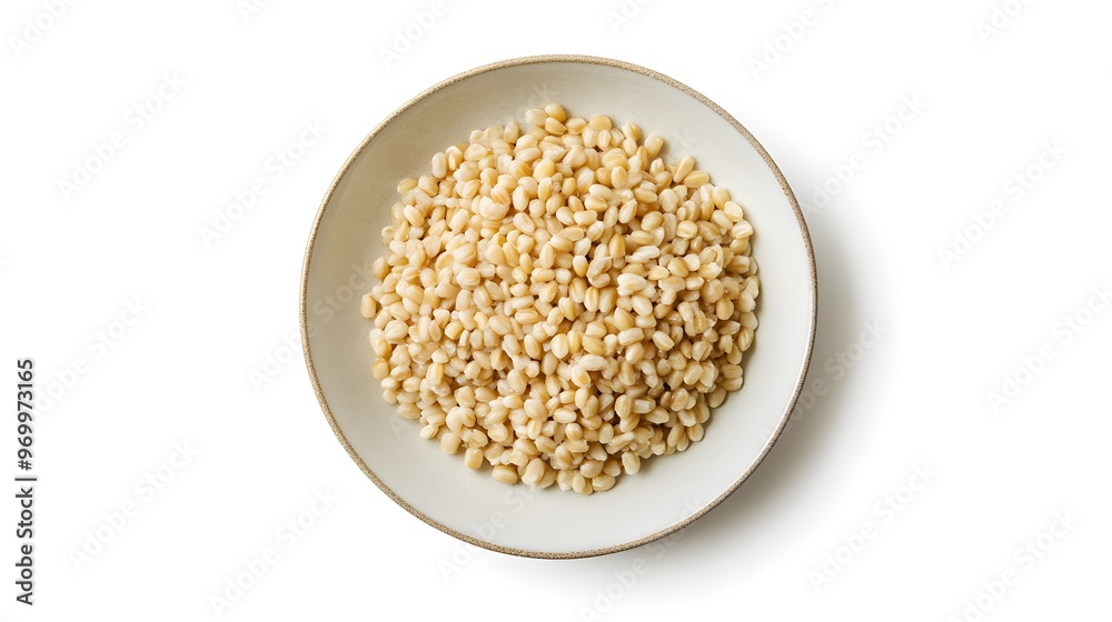 Top view of organic pine nuts on ceramic plate against white background Top view of organic pine nuts on ceramic plate against white background
