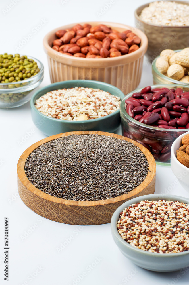 Variety of grains, nuts, seeds, legumes in bowls on a light background. Healthy foods. Healthy lifestyle, Vegetarianism. Variety of grains, nuts, seeds, legumes in bowls on a light background. Healthy foods. Healthy lifestyle, Vegetarianism.