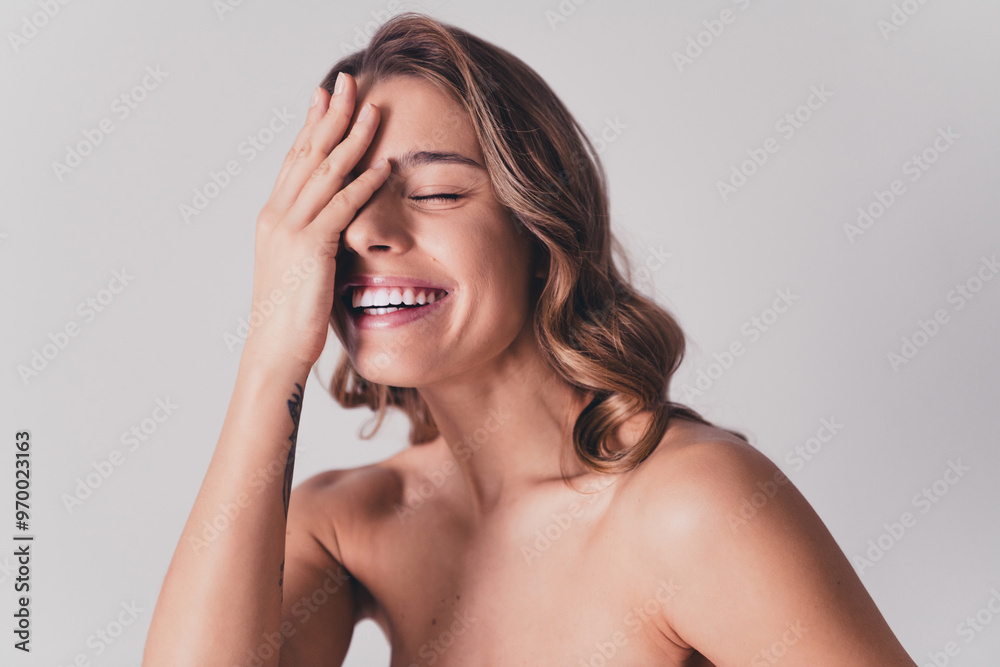 Fototapeta premium Photo of lovely young lady touch face laugh toothy smile no retouch bare shoulders isolated on gray color background