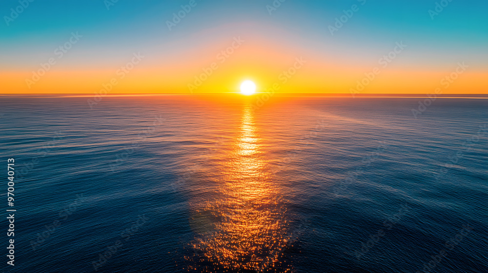 Obraz premium A stunning ocean view from a high balcony with the sun rising over the horizon and casting a golden glow on the water.