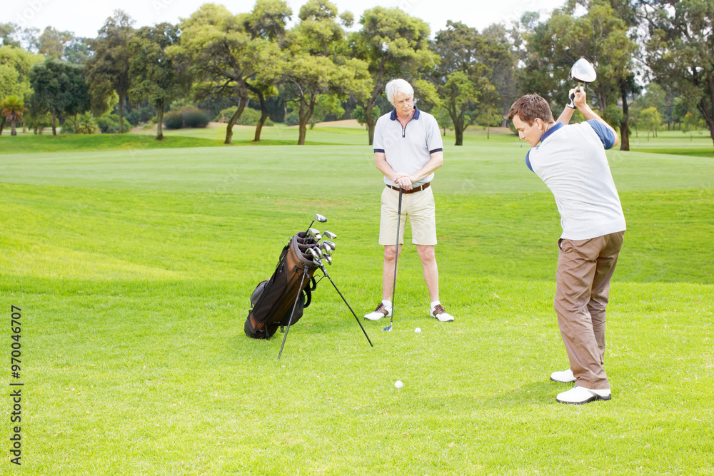 Swing, play and men on golf course together for teamwork, outdoor fun and fitness competition in nature. Sports, senior father and son on green for partnership, bonding and support in club challenge Swing, play and men on golf course together for teamwork, outdoor fun and fitness competition in nature. Sports, senior father and son on green for partnership, bonding and support in club challenge