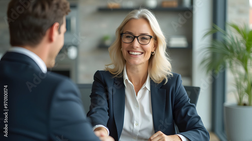 Happy mid aged business woman manager handshaking at office meeting. Smiling female hr hiring recruit at job interview, bank or insurance agent, lawyer making contract deal with client at work.  photo