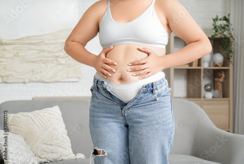 Overweight young woman touc...