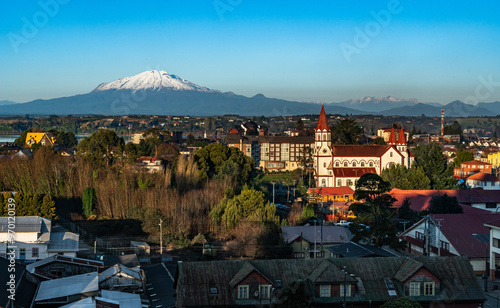 Skyline of the city of Puerto Varas on a clear and sunny winter day, with the Calbuco volcano by Lake Llanquihue, Chilean Patagonia. photo