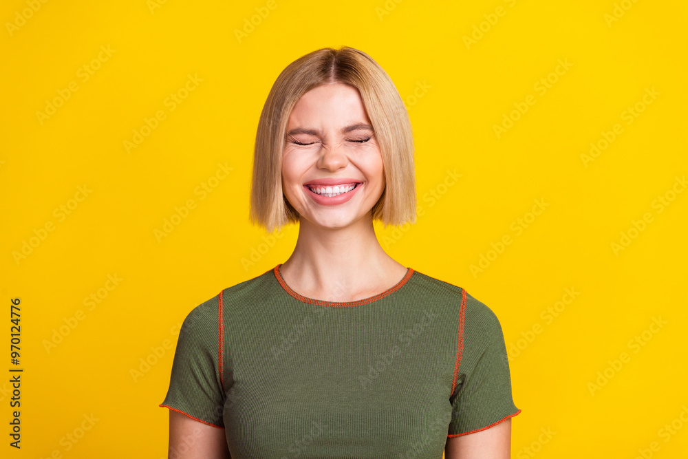 Photo of funky good mood cheerful girl with bob hairstyle dressed khaki t-shirt laughing smiling isolated on yellow color background Photo of funky good mood cheerful girl with bob hairstyle dressed khaki t-shirt laughing smiling isolated on yellow color background