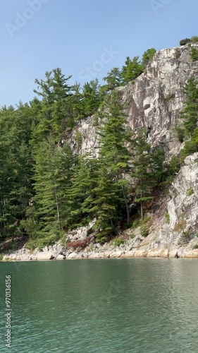 White quartzite cliffs pine forests and calm water in Covered Portage Cove near Killarney Provincial Park, Ontario Canada photo