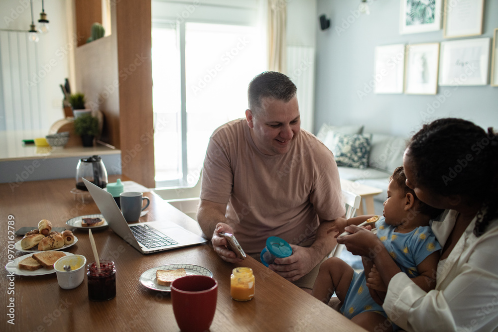 Family breakfast with baby and parents working from home Family breakfast with baby and parents working from home