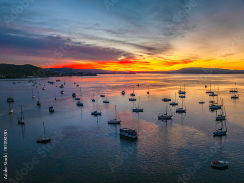 Aerial sunrise waterscape with boats and high cloud photo