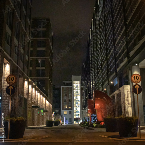 A view of Dublin's Docklands featuring tall modern buildings on the left side, with striking red pipes on the right.