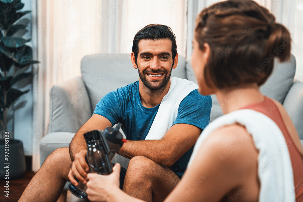 Athletic body and sporty young couple or workout buddy in sportswear warmup or resting after finishing in home workout exercise at gaiety home exercise and healthy lifestyle concept. Athletic body and sporty young couple or workout buddy in sportswear warmup or resting after finishing in home workout exercise at gaiety home exercise and healthy lifestyle concept.
