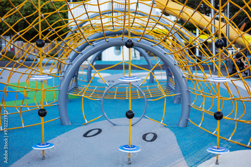A close-up of the colorful climbing nets and play structures at Frank Kitts Park Playground in Wellington, New Zealand