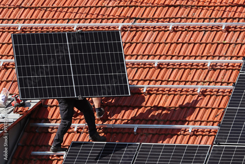 Aufbau von einer Photovoltaik Anlage auf einem Hausdach photo