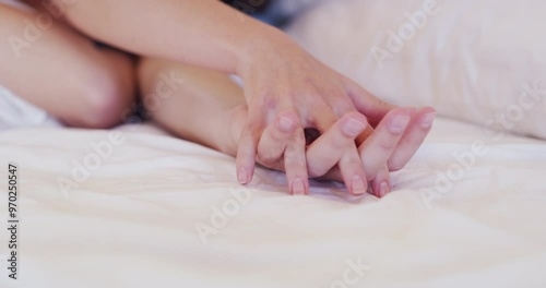 Couple, hand holding and love in bed closeup for happy partnership, romance or marriage celebration. People, fingers and intimate dating for waking up in morning or connection, relax peace or calm