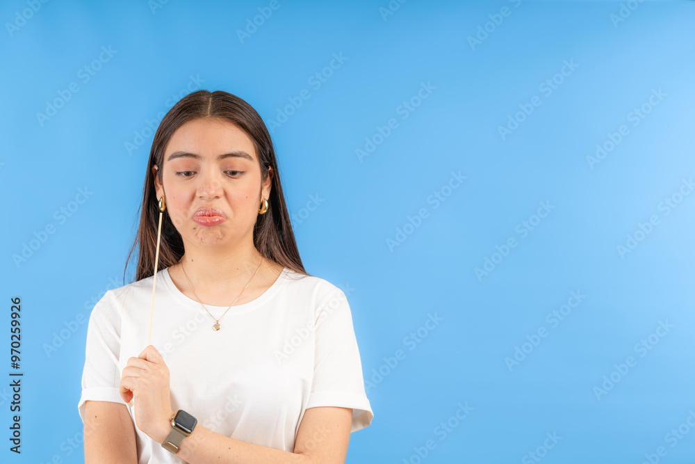 Young woman making a sad face expression on blue background Young woman making a sad face expression on blue background