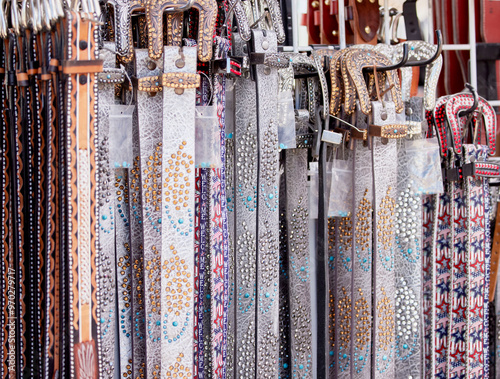 A Stack of Western Style Cowboy Hats on a Rack for Sale photo