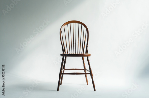 a traditional windsor chair with a curved backrest and spindle design