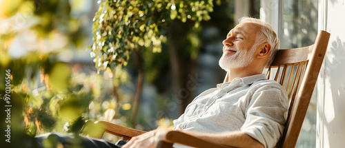 Senior man relaxing in a rocking chair on a porch