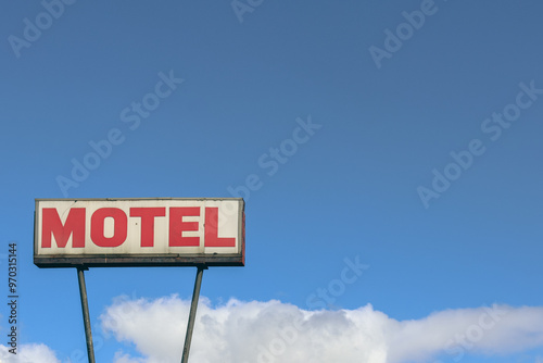 vintage motel sign against blue sky