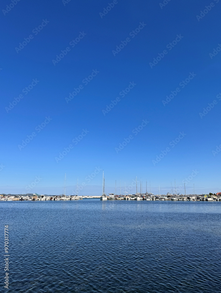 boats in a row in harbor against clear blue sky on a sunny day with space for text in Bibinje, Croatia boats in a row in harbor against clear blue sky on a sunny day with space for text in Bibinje, Croatia