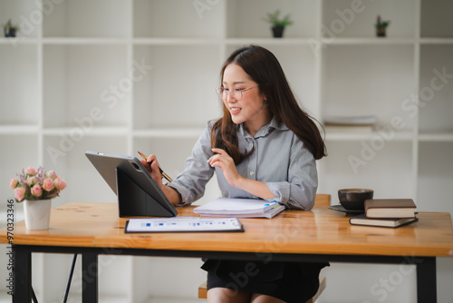 Focused Female Professional Analyzes Data in Modern Workspace 