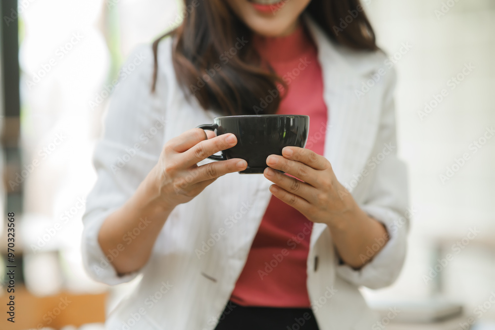 Coffee Break: A close-up of a woman enjoying a warm beverage while scrolling through her smartphone, showcasing a moment of relaxation and connection during a busy day. Coffee Break: A close-up of a woman enjoying a warm beverage while scrolling through her smartphone, showcasing a moment of relaxation and connection during a busy day.