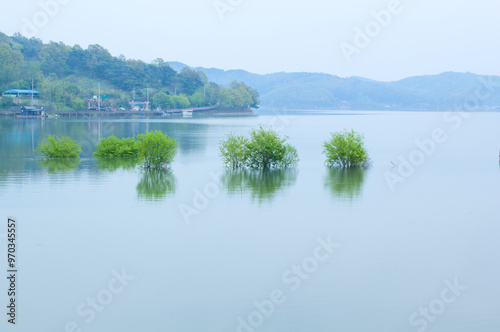 Yesan-gun, Chungcheongnam-do, South Korea - April 28, 2019: Aerial view of fishing houses and willow trees on Yedang Reservoir in spring photo