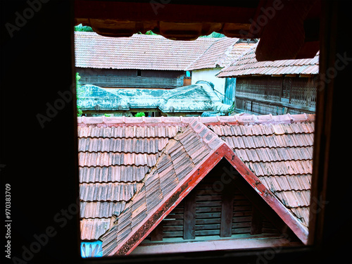  A close up image showcasing the intricate details of a traditional Kerala style tiled roof in Padmanabhapuram palace. photo