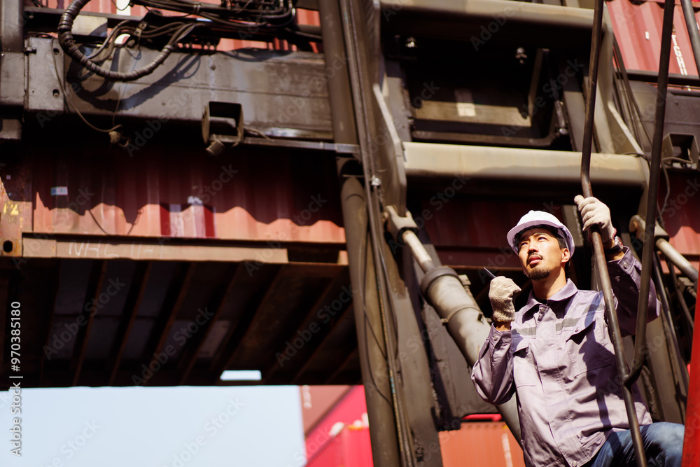 Asian male container yard worker perform an inspection. Asian male container yard worker perform an inspection.