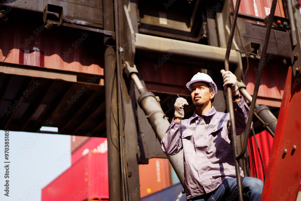 Asian male container yard worker perform an inspection. Asian male container yard worker perform an inspection.