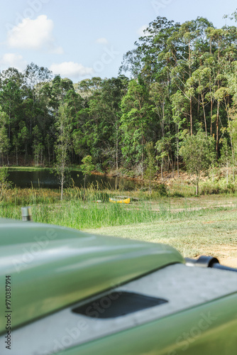 Land Rover Defender at camp with a yellow canoe