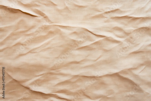 Close-up of crumpled beige fabric, showcasing textures and patterns for artistic or design purposes.