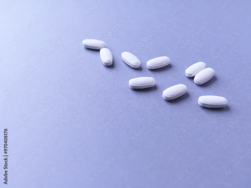Amino acids tablets. Nutrition for bodybuilding. Fitness supplements on bright paper background. Soft focus. Copy space. Amino acids tablets. Nutrition for bodybuilding. Fitness supplements on bright paper background. Soft focus. Copy space.