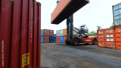 Timelapse of Massive Container Handlers Efficiently Moving and Stacking Shipping Containers in a Busy Port Yard
