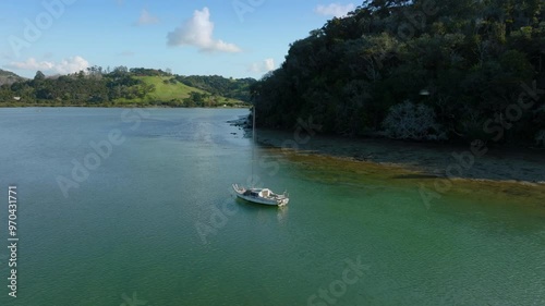 Boat on the Puhoi River estuary and Wenderholm Regional Park, Auckland, New Zealand. photo