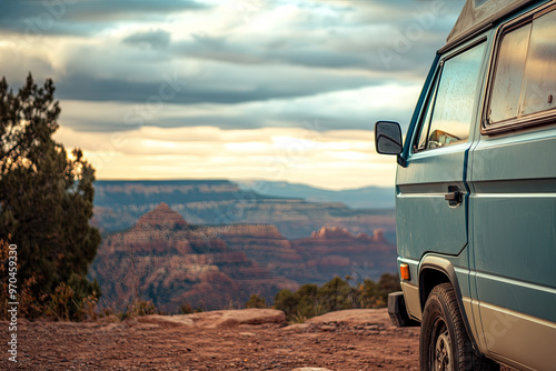 Camper van parked at a scenic overlook with mountains in the background photo