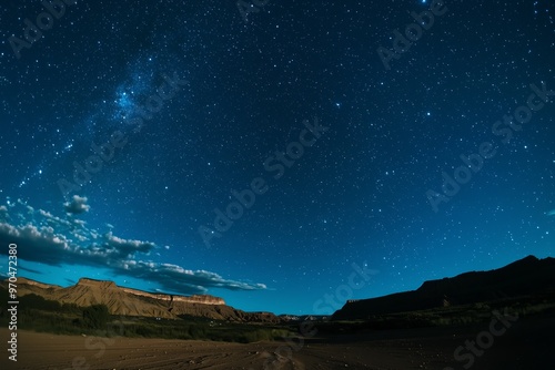 Clear night sky filled with stars above a rugged desert landscape, showcasing the beauty of nature and the cosmos.