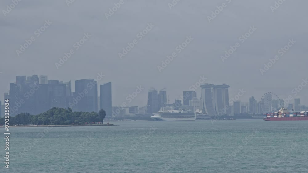 Singapore skyline with marina bay sands in the distance and ships sailing in calm waters Singapore skyline with marina bay sands in the distance and ships sailing in calm waters