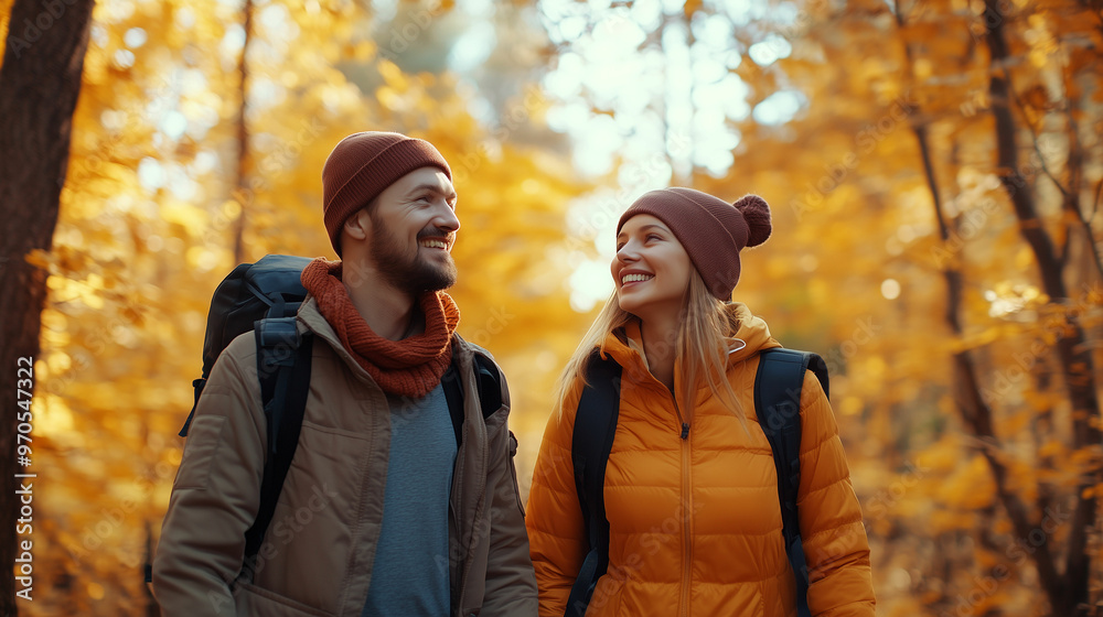 Couple enjoys a joyful autumn hike through a vibrant forest filled with golden leaves Couple enjoys a joyful autumn hike through a vibrant forest filled with golden leaves