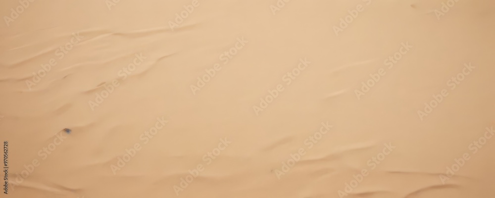 a close-up view of a sandy beach, with the sand's undulating texture and small grains visible. a close-up view of a sandy beach, with the sand's undulating texture and small grains visible.