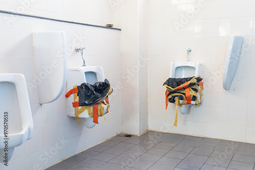 The urinal in the men's toilet was closed.Ceramic urinal in public toilet for men that was blocked due to blockage.