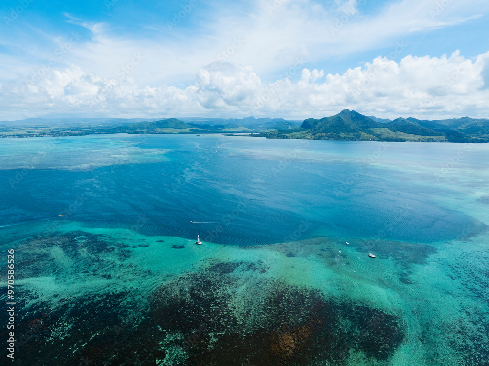 Aerial view of Indian Ocean with beautiful blue waters and islands in the background. Mauritius Aerial view of Indian Ocean with beautiful blue waters and islands in the background. Mauritius