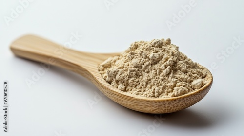 A bamboo spoon filled with taro powder, set against a plain white background, highlighting its smooth and vibrant color