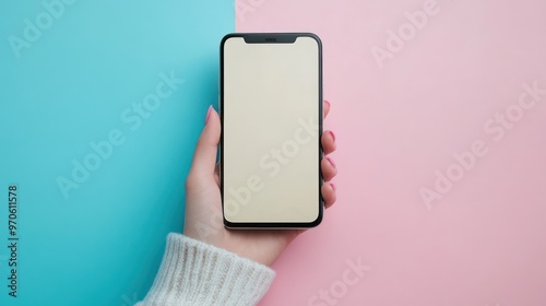close-up hand holding smartphone blank screen for text and content with pastel background